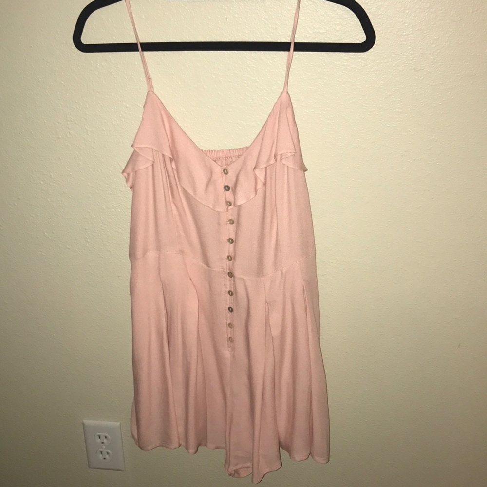 Pink romper with pleated skirt detail
